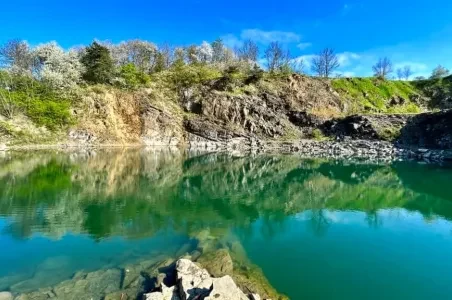 Natural swimming lake with cliffs and trees