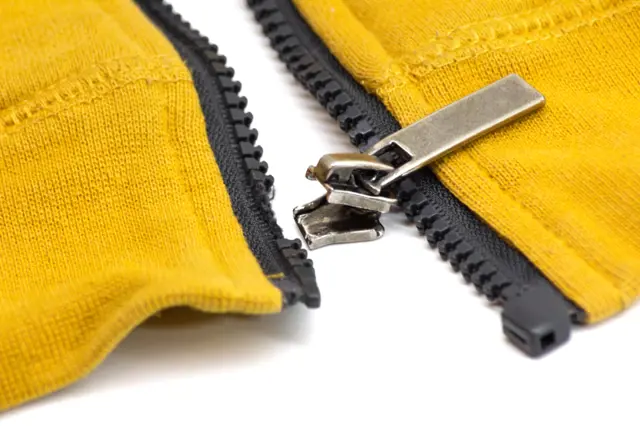 Broken zipper on yellow fabric