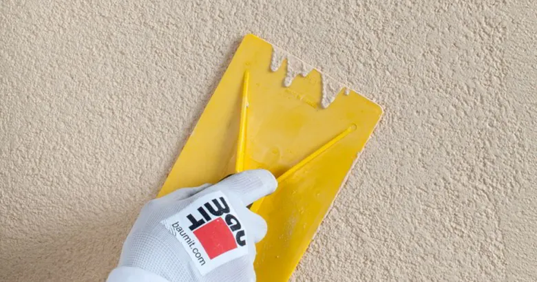Plastering wall with trowel