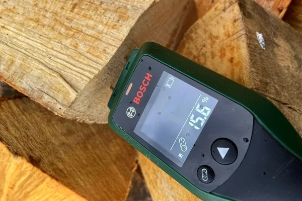 Wood moisture meter on log