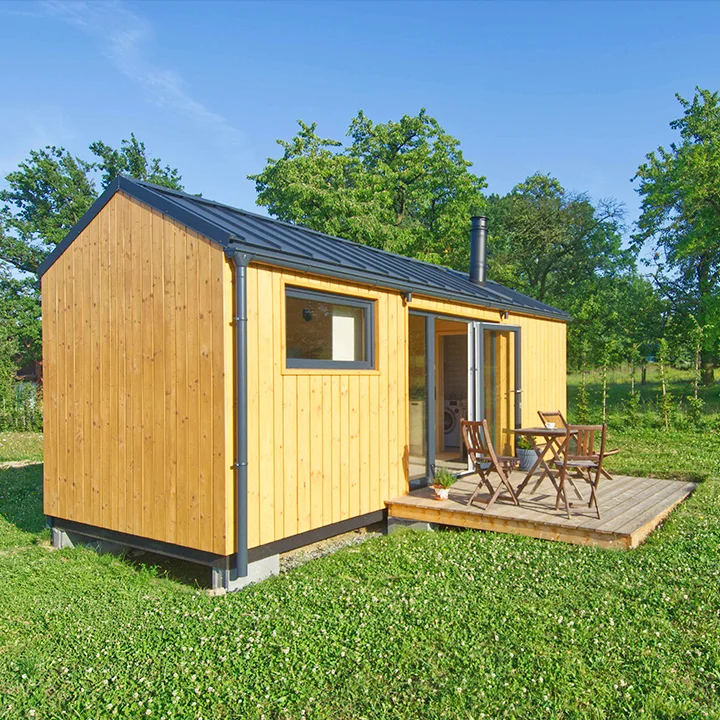 Moderní dřevěný domek pro trvalé bydlení s terasou.