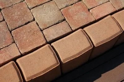 Červené tvárnice na svahu pro stavbu terasy nebo chodníku.