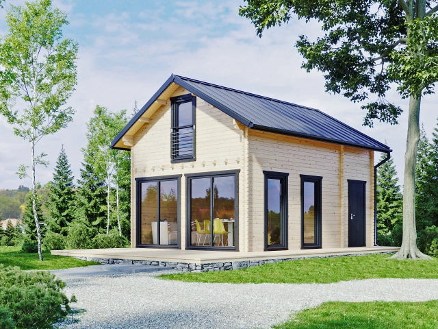 Moderní montovaná dřevěná chata s velkými okny v zeleném prostředí.