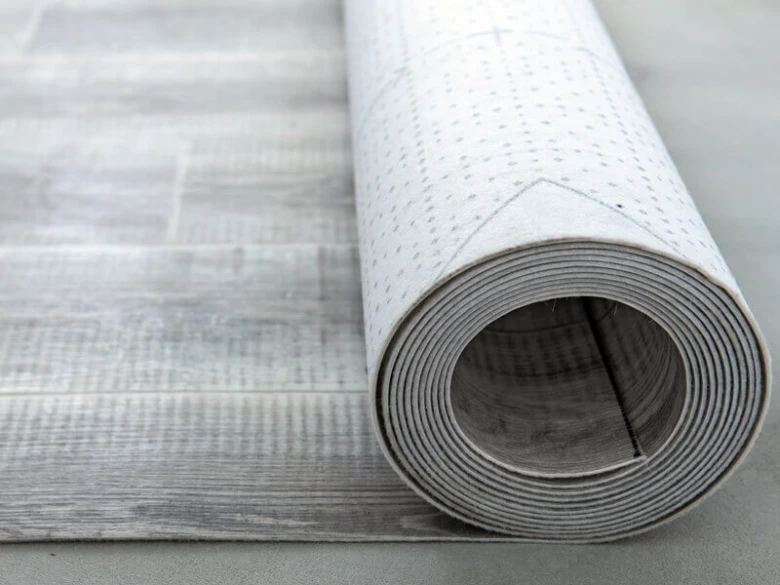 Svinutý lino podlahový materiál s viditelnou texturou vzoru.