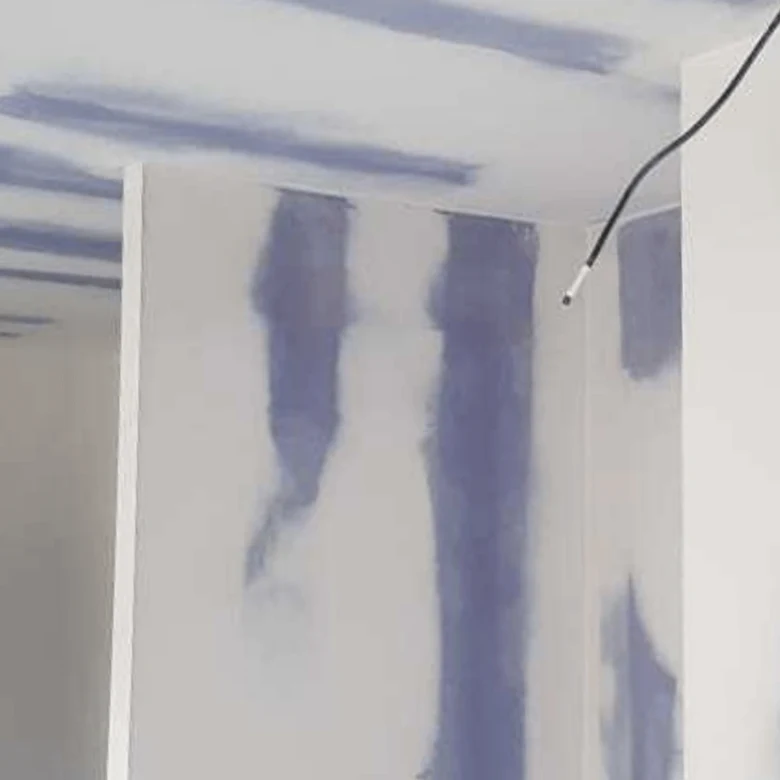 Náplast na spoje sádrokartonu během procesu tmelení.