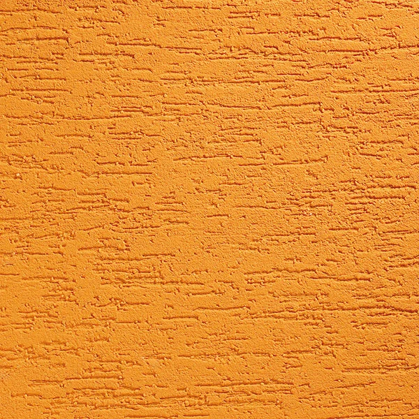 Příklad oranžové venkovní omítky s texturovanou povrchovou úpravou.