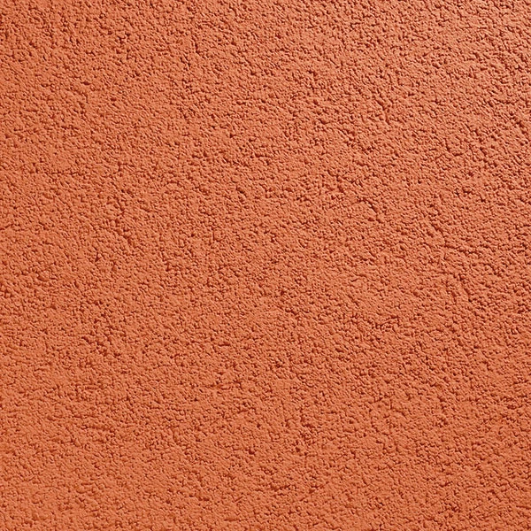 Texturovaná venkovní omítka s oranžovou barvou.