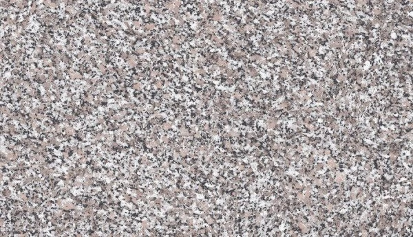 Detail textury granitové kuchyňské desky s bílými a růžovými skvrnami.